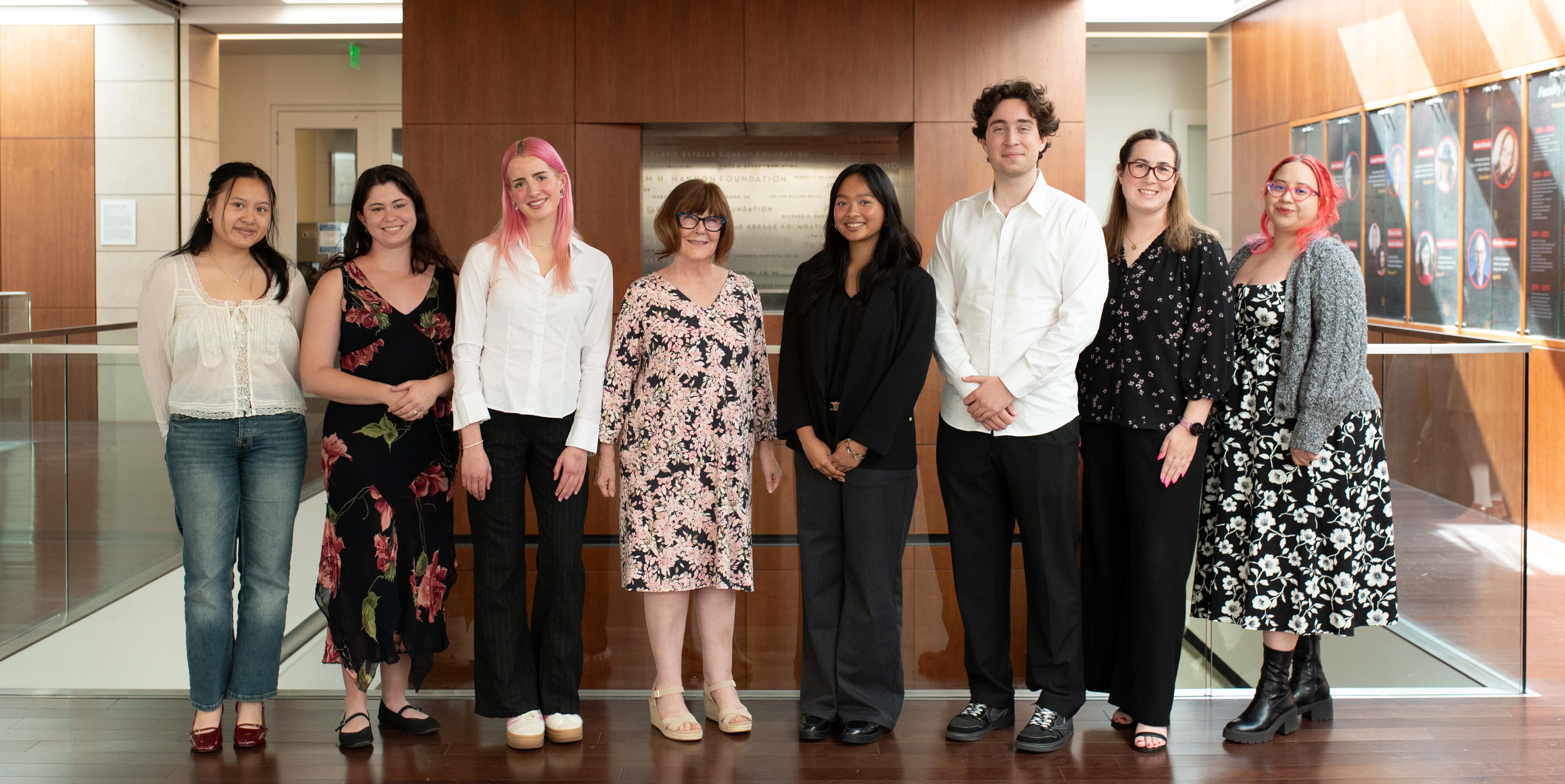 seven students standing alongside library dean